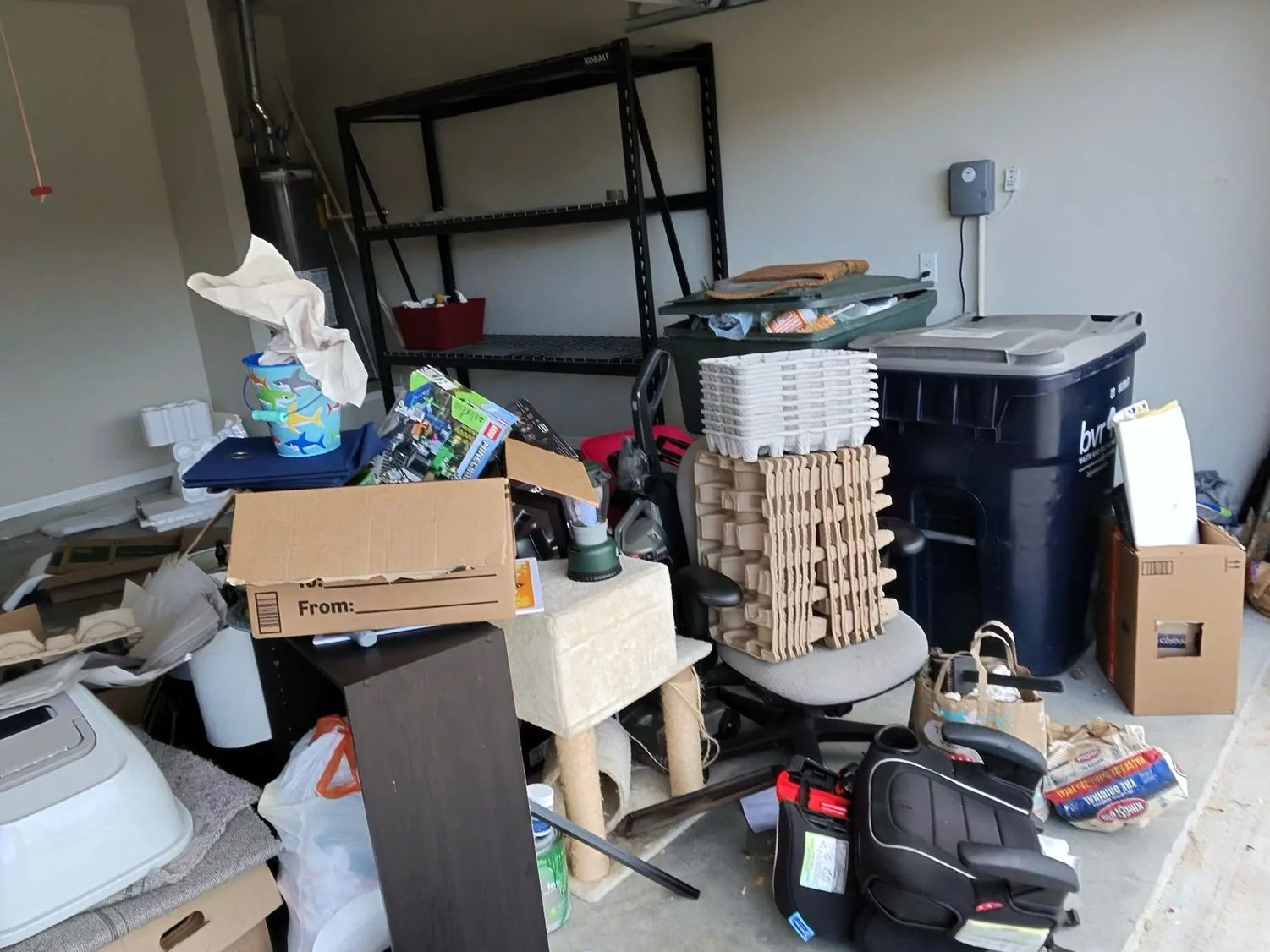 Cluttered two-car garage in Bryan-College Station before an ME3 Junk Solutions cleanout