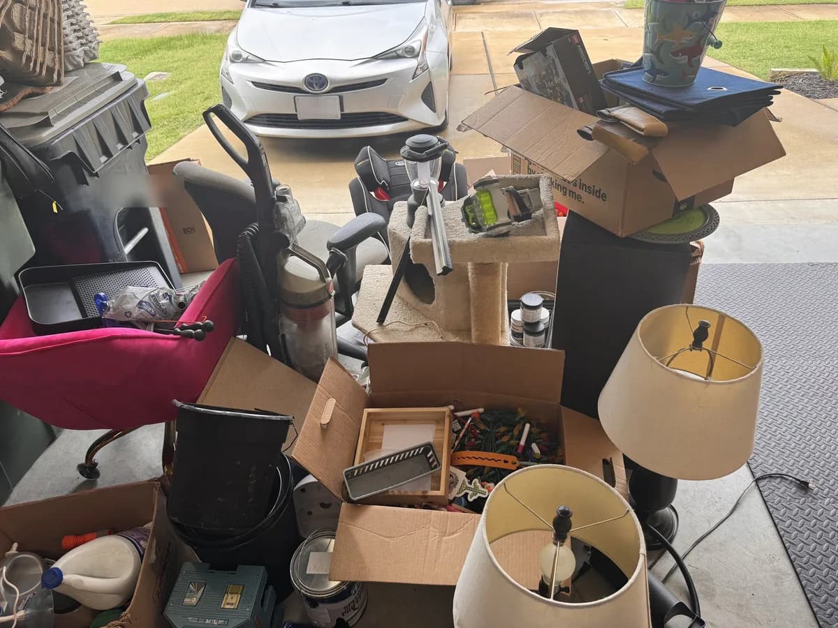 Household items staged in a driveway for ME3 Junk Solutions pickup