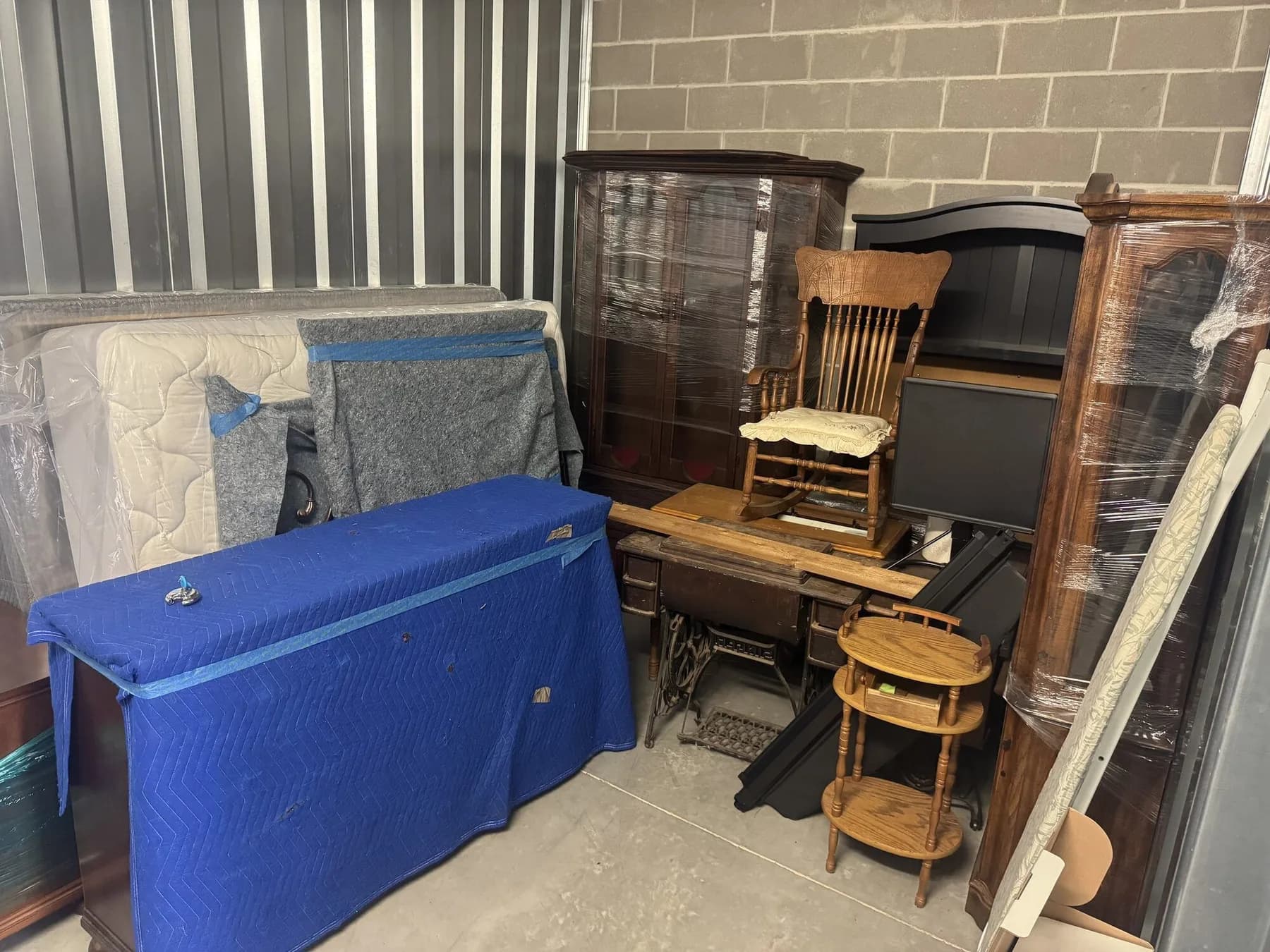 Furniture in a storage unit before an ME3 Junk Solutions estate and transition cleanout