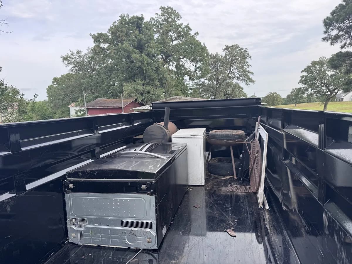 ME3 Junk Solutions trailer loaded with appliances and scrap metal